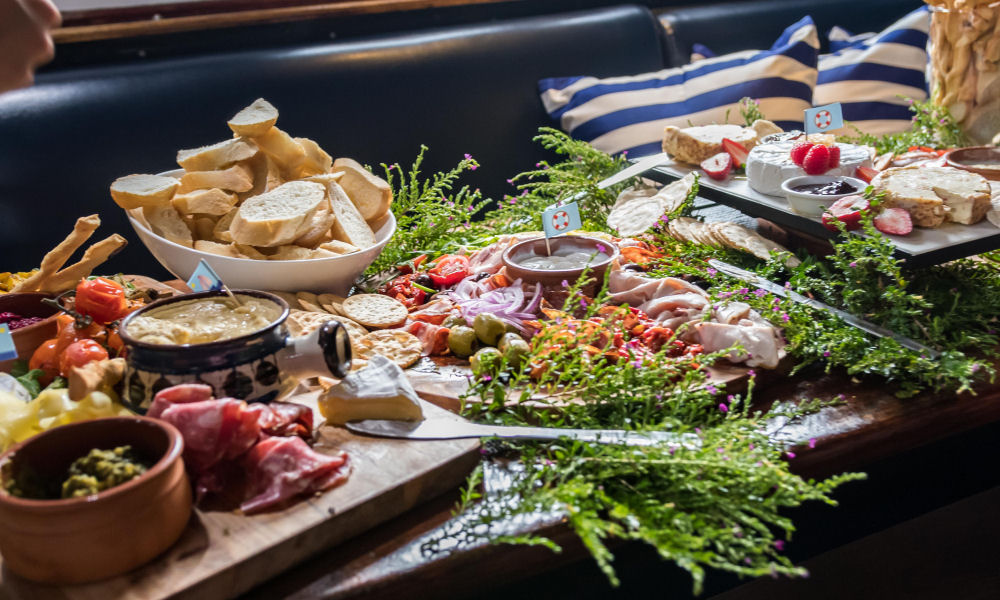 Freshly prepared platters on the tables within the Saloon of Atlantic Clipper