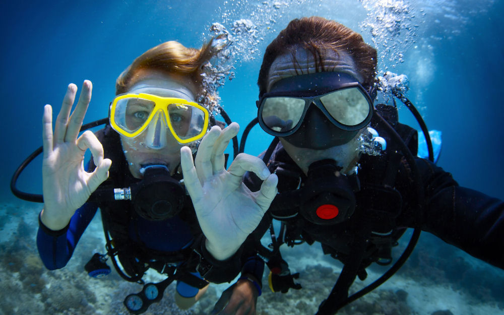 Two people scuba diving at the fringing Great Barrier Reef Marine Park